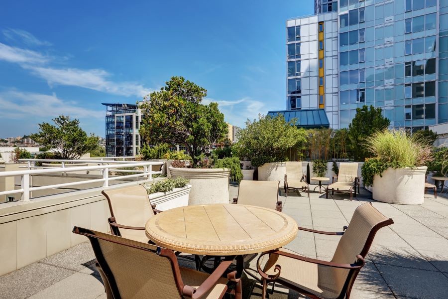 Outdoor seating in a mixed-use area in front of luxury apartments.