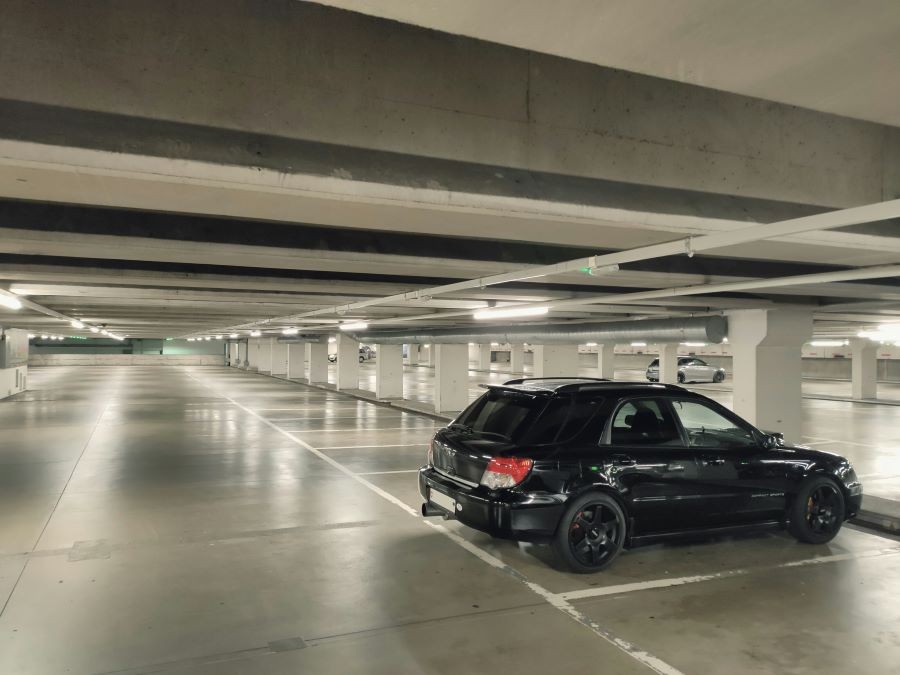  A black car in a parking garage.