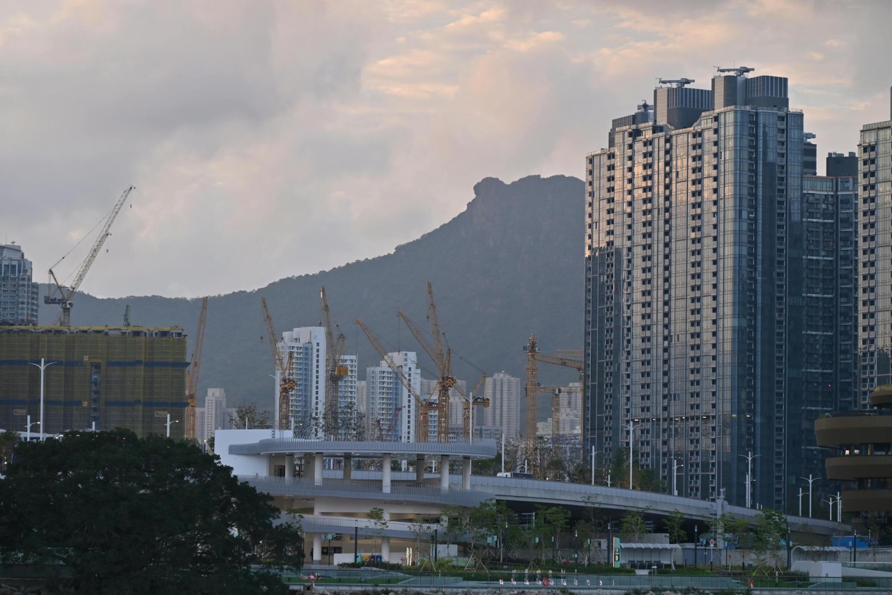 A construction site set against an urban skyline.