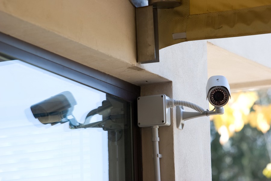 A security camera with a motion detector alarm system installed in a commercial space