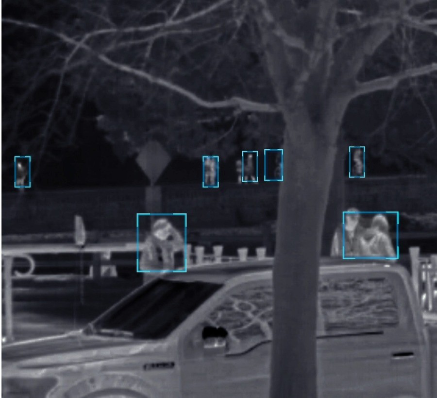  a thermal imaging camera monitoring the crowd in a public space